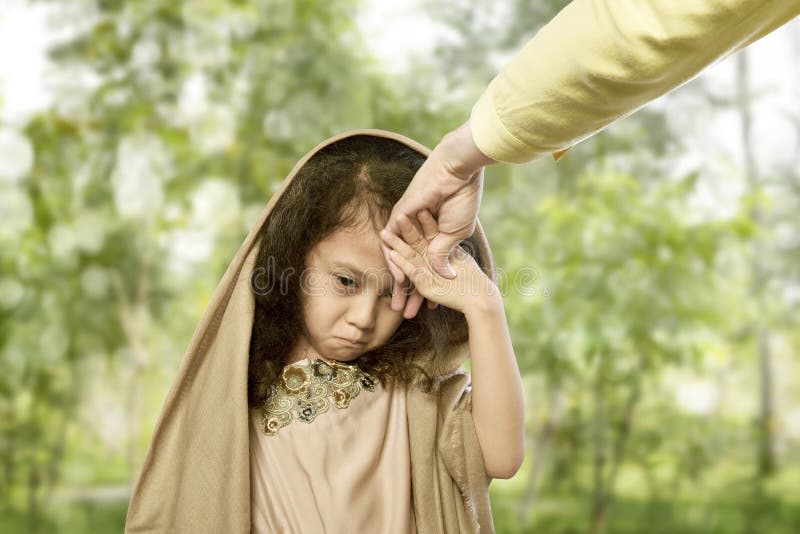 Asian muslim child kissing hand parents for traditional act of r stock photos Asian muslim child kissing hand parents for traditional act of r stock photos