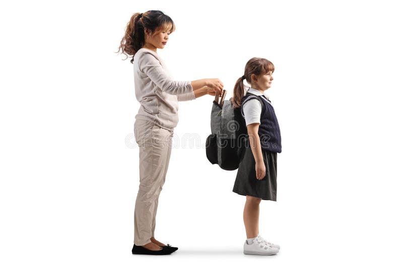 Asian nanny helping a girl with her school backpack royalty free stock photo