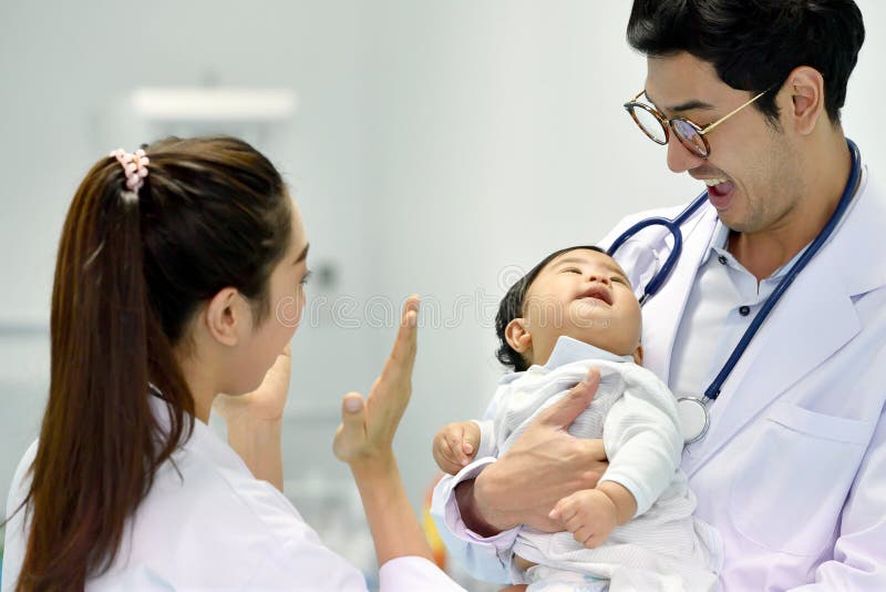 Asian paediatrician is taking care of baby royalty free stock images Asian paediatrician is taking care of baby royalty free stock images