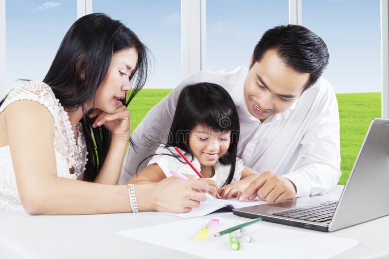 Asian Parents Teach Their Daughter To Study Stock Image