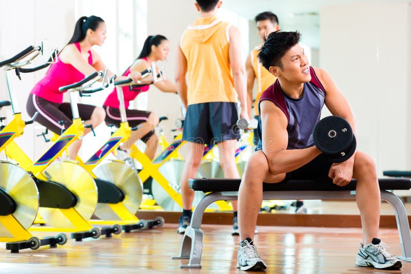 Asian Chinese Female Barbell Workout Exercise At Gym Stock Photo