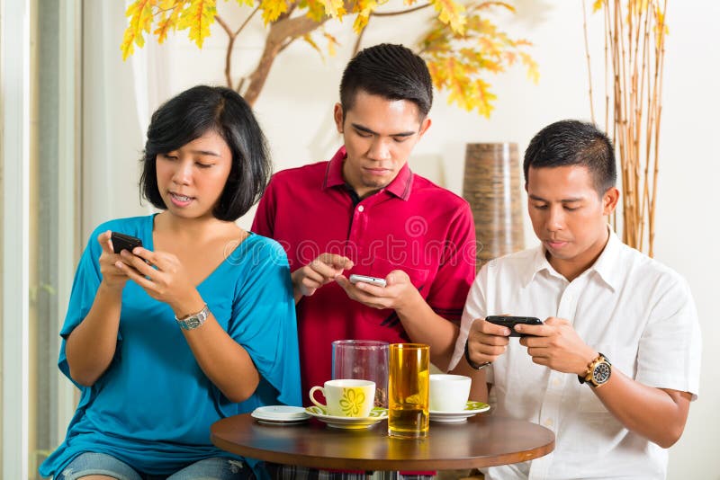 Asian people having fun with mobile phone stock photos Asian people having fun with mobile phone stock photos