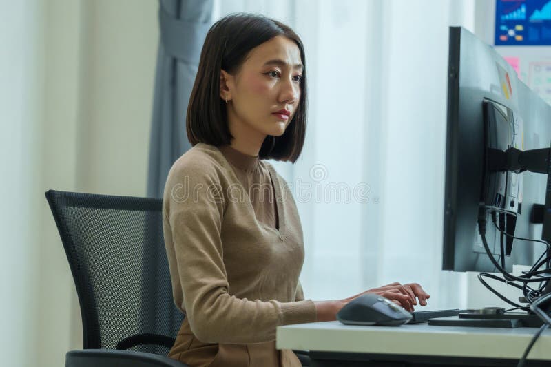 Asian prompt engineer develop coding app with software data sitting in front of computer monitor at office royalty free stock photos