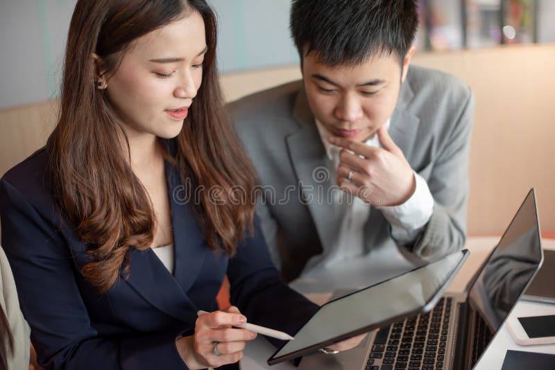 Asian secretary showing manager project report stock photos Asian secretary showing manager project report stock photos