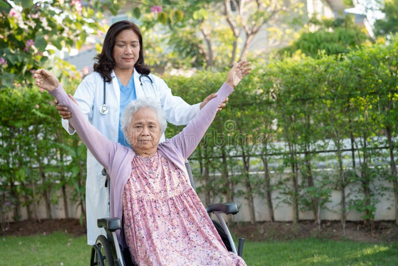 Asian senior or elderly old woman exercise with doctor in park, healthy strong medical concept