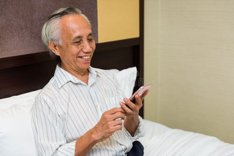Asian senior male with phone