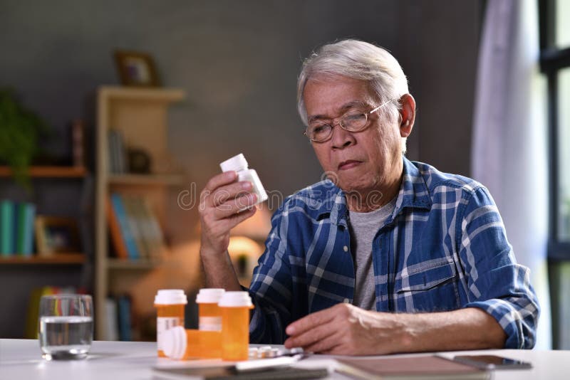 Asian senior man  with his medicine bottles
