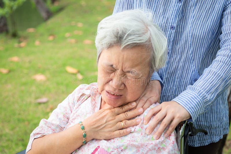 Asian senior mother have nerve pain,shoulder and neck pains,female caregiver or daughter massaging her shoulders elderly woman, stock images Asian senior mother have nerve pain,shoulder and neck pains,female caregiver or daughter massaging her shoulders elderly woman, stock images