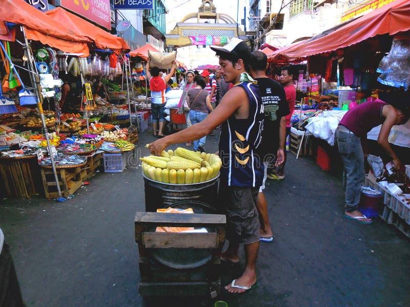 Asian Street Vendor Selling Steamed Corn On A Cob In Quiapo, Manila