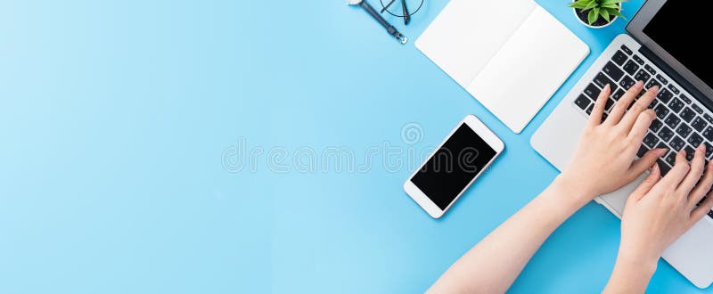 Asian student surf internet for job hunting. Freelancer blog writer typing isolated on a minimal clean blue desk concept stock photos