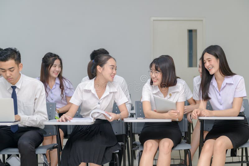 Asian students sitting in a classroom and talking stock photography