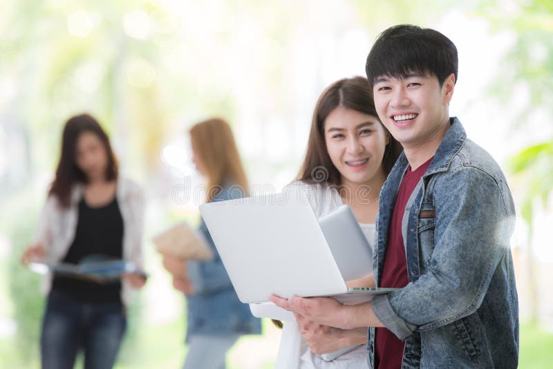 Asian students in university use computer notebook stock photos