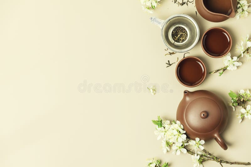 Asian Tea Set on Stone Slate Board, Ceramic Teapot, Cups, Dried Tea and Spring Branches Stock