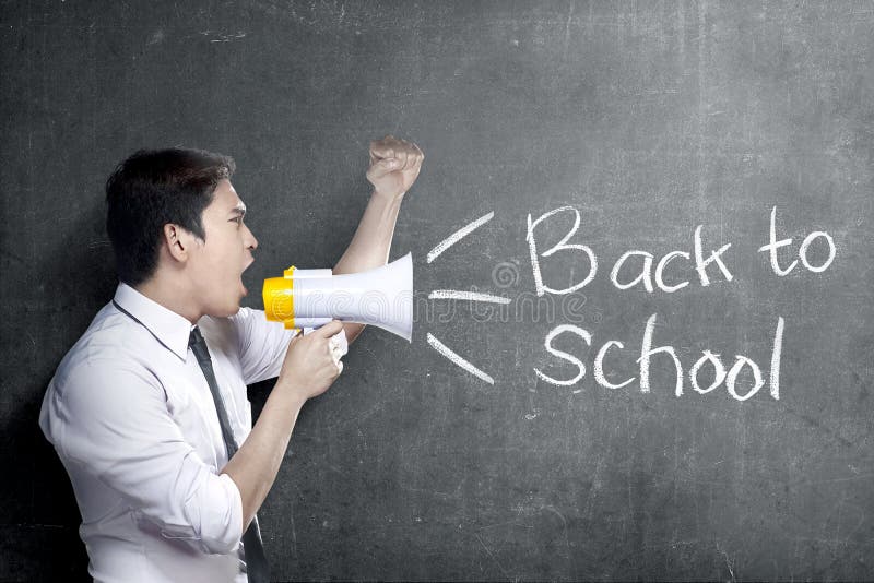 Asian teacher man using megaphone to notify for go back to school with blackboard background royalty free stock photos Asian teacher man using megaphone to notify for go back to school with blackboard background royalty free stock photos