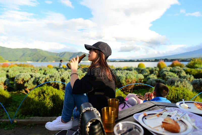 Asian Teenager girl enjoy and holding bottle of beer