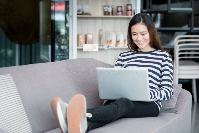 Asian teenager girl using laptop computer and sitting cross legs royalty free stock photo Asian teenager girl using laptop computer and sitting cross legs royalty free stock photo