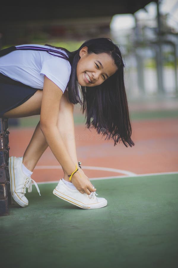 Asian teenager wearing sneaker shoe in indoor sport club. Asian teenager wearing sneaker shoe in indoor sport club royalty free stock image Asian teenager wearing sneaker shoe in indoor sport club. Asian teenager wearing sneaker shoe in indoor sport club royalty free stock image