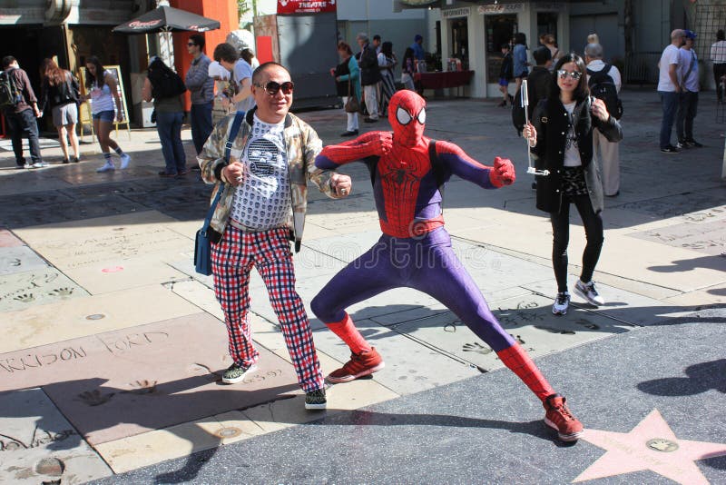 Asian tourist poses with Spiderman stock image Asian tourist poses with Spiderman stock image