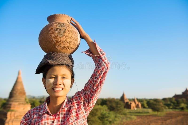 Asian traditional female farmer carrying clay pot on head royalty free stock photos Asian traditional female farmer carrying clay pot on head royalty free stock photos