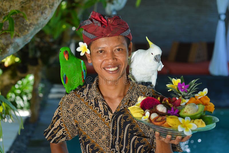 Asian waiter with a tray of tropical fruits