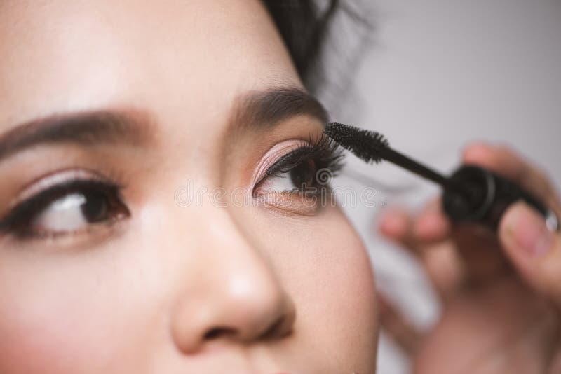 An Asian Woman Applying Mascara on Her Eyelashes Stock Photo Image of