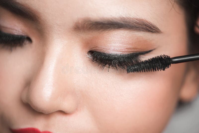 An Asian Woman Applying Mascara on Her Eyelashes Stock Photo Image of