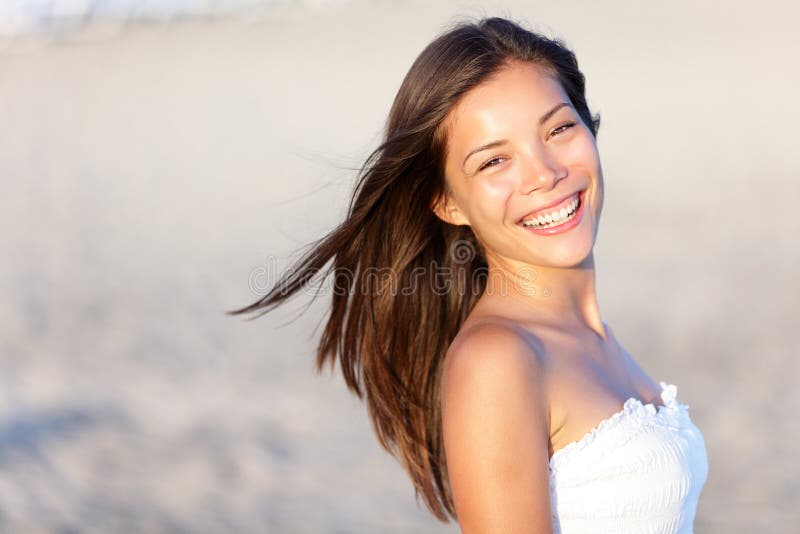 Asian woman on beach smiling happy. Beautiful young mixed race Asian Chinese / white Caucasian girl outdoors on summer beach.