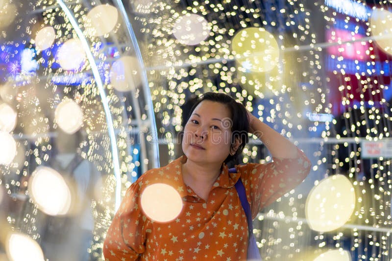 Asian woman with bokeh of light for happy new year stock photography