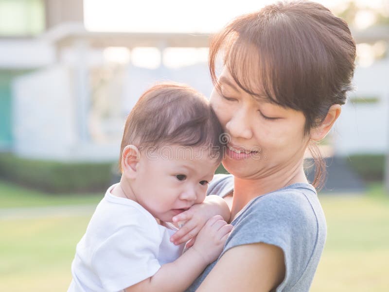 Asian woman carrying her baby.