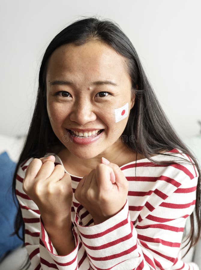 Asian woman cheering world cup with painted national flag