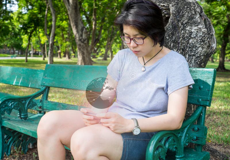 Asian woman connect to the whole world using her smartphone royalty free stock photo Asian woman connect to the whole world using her smartphone royalty free stock photo