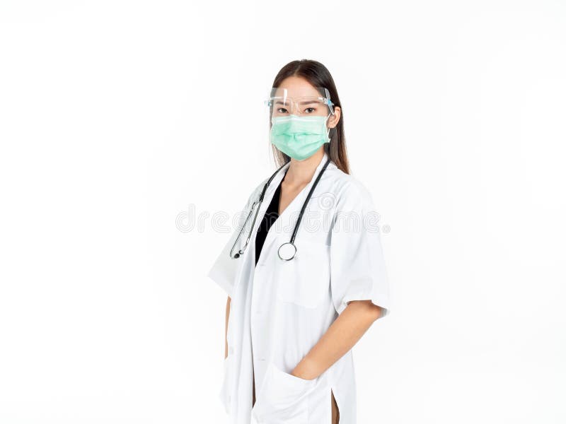 Asian woman doctor wearing green medical face mask, face shield and white coat with stethoscope. Portrait of young attractive