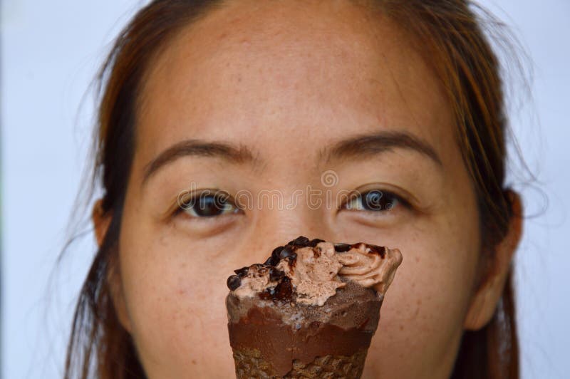 Asian woman enjoy with chocolate ice cream stock photography
