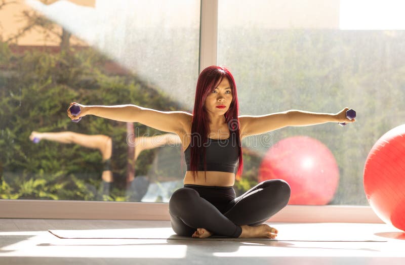 Asian woman exercising with dumbbells stock images