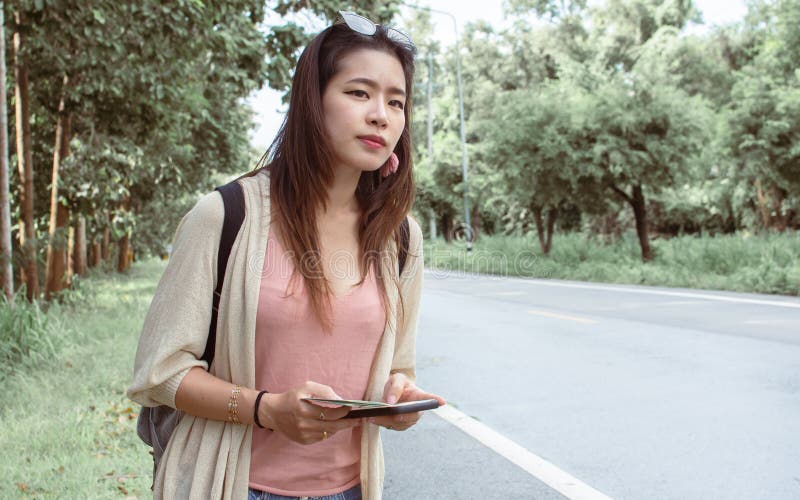 Asian Woman Get Lost And Hitchhiking Beside The Street While Traveling Alone Stock Image Image