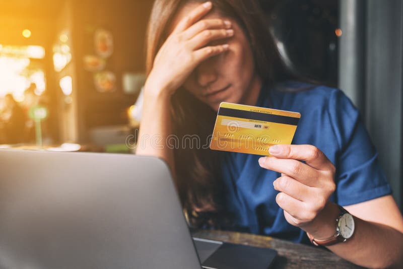 An Asian woman get stressed and broke while holding credit card stock photos An Asian woman get stressed and broke while holding credit card stock photos