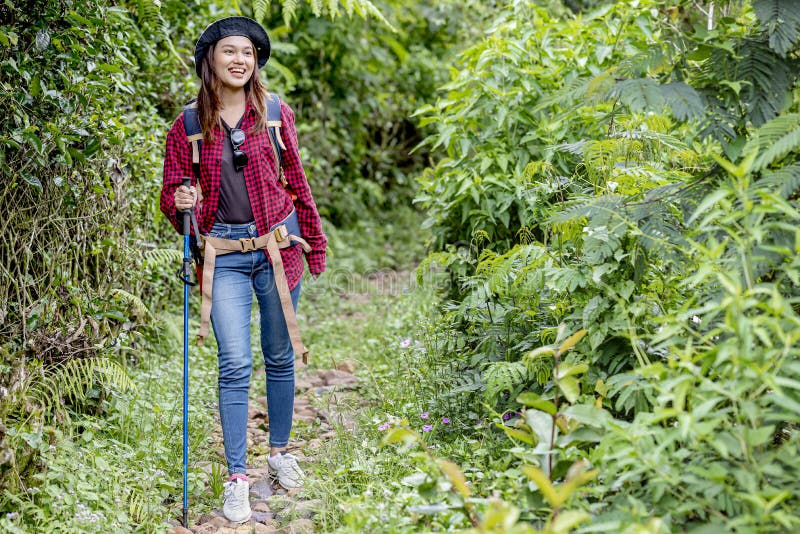 Asian Woman in a Hat and Backpack with a Trekking Pole Stock Image