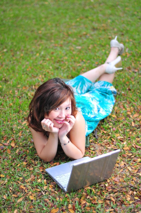 Asian Woman In The Park With Laptop