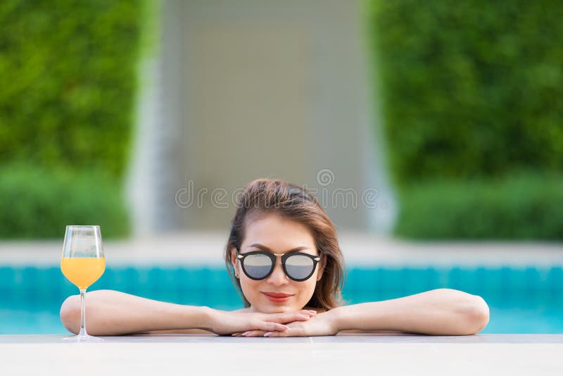 Asian Woman in Pool with Glass of Orange Juice Stock Image - Image of ...