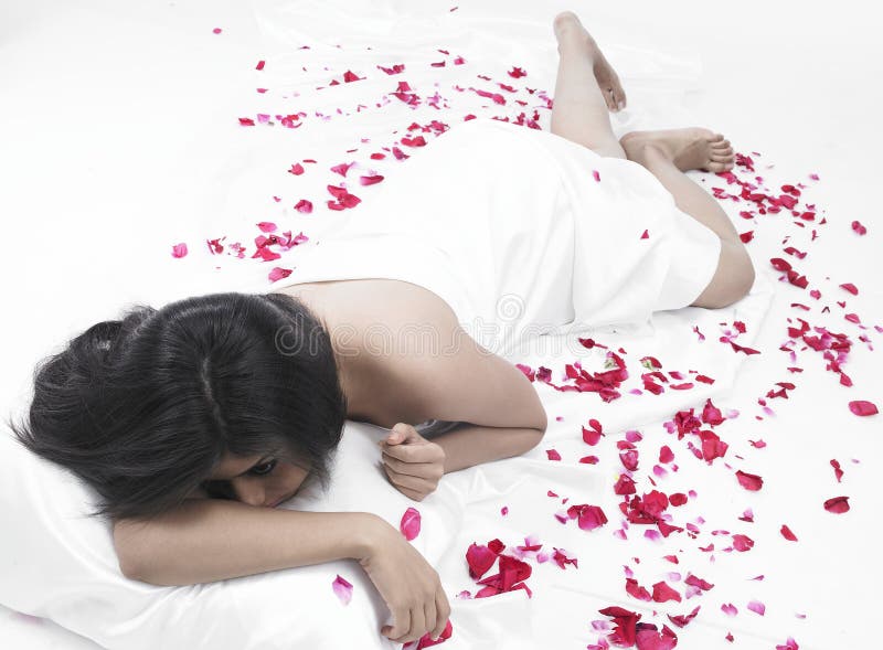 Asian woman with rose petals