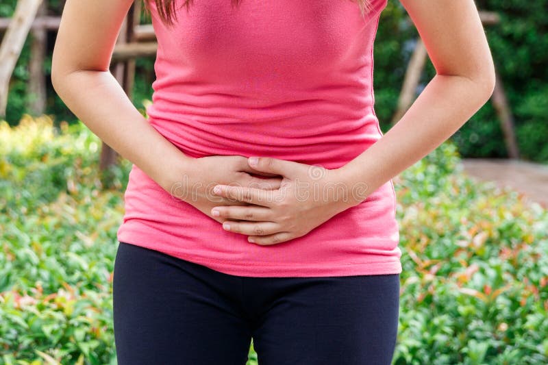 Asian woman touching her own underbelly with stomachache or menses.