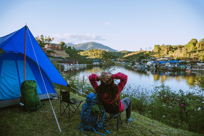 Asian woman travel nature. Travel relax, Camping in a rural village on the mountain, near the lake royalty free stock photos Asian woman travel nature. Travel relax, Camping in a rural village on the mountain, near the lake royalty free stock photos