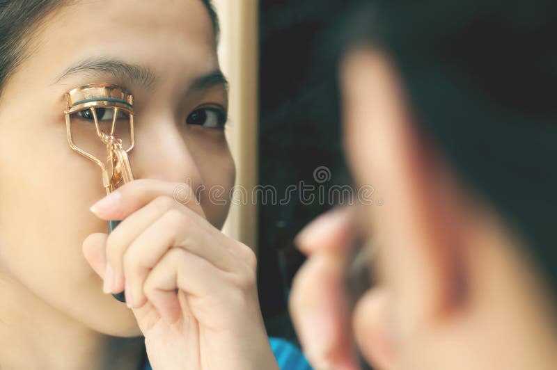 Asian Woman is Using Eyelash Curler. Stock Photo Image of lady
