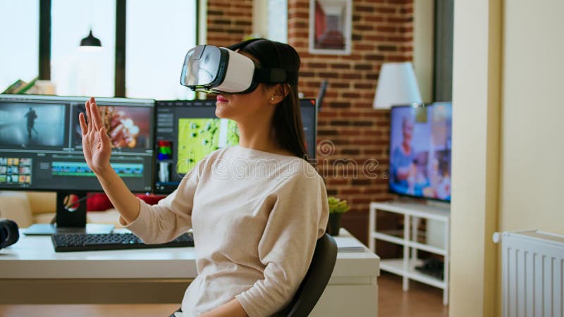 Asian woman video creator uses virtual reality headset at her desk stock images