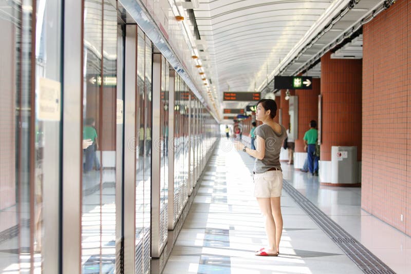 Asian woman waiting for train