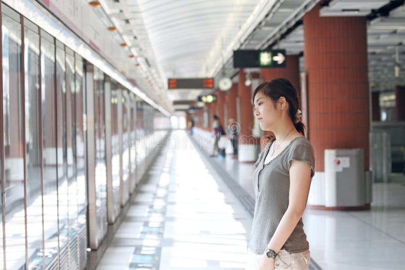 Asian woman waiting for train