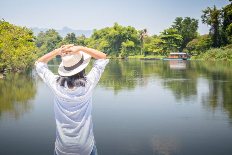 Woman looking forward to river with put her hands on head and she has feeling relax and happiness. royalty free stock images Woman looking forward to river with put her hands on head and she has feeling relax and happiness. royalty free stock images