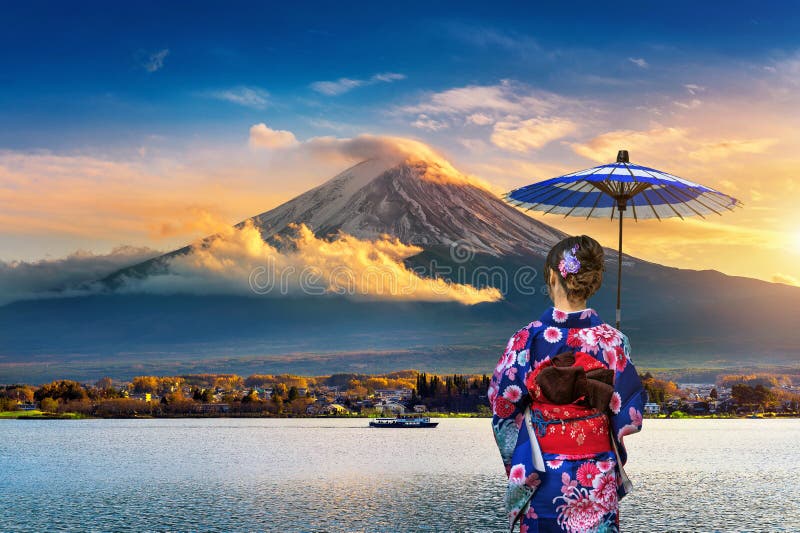 Asian woman wearing japanese traditional kimono at Fuji mountain. Sunset at Kawaguchiko lake in Japan