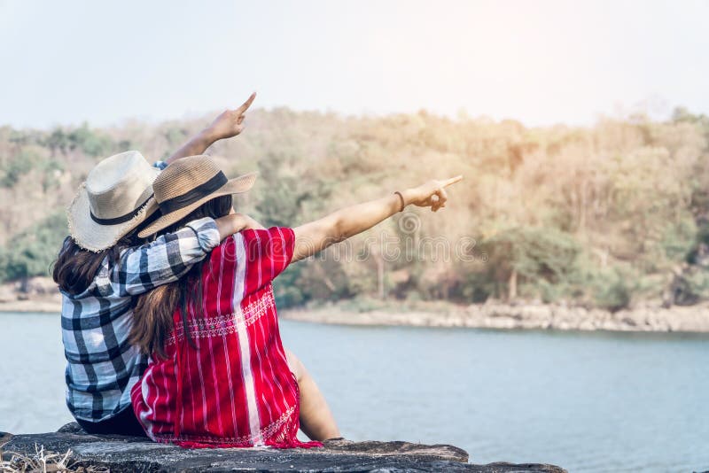 Asian women backpack on the park journey and traveling on holiday stock photos Asian women backpack on the park journey and traveling on holiday stock photos