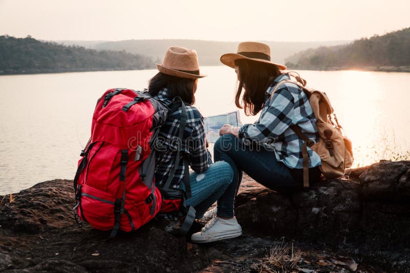 Asian women backpack on the park journey and traveling on holiday royalty free stock photos Asian women backpack on the park journey and traveling on holiday royalty free stock photos
